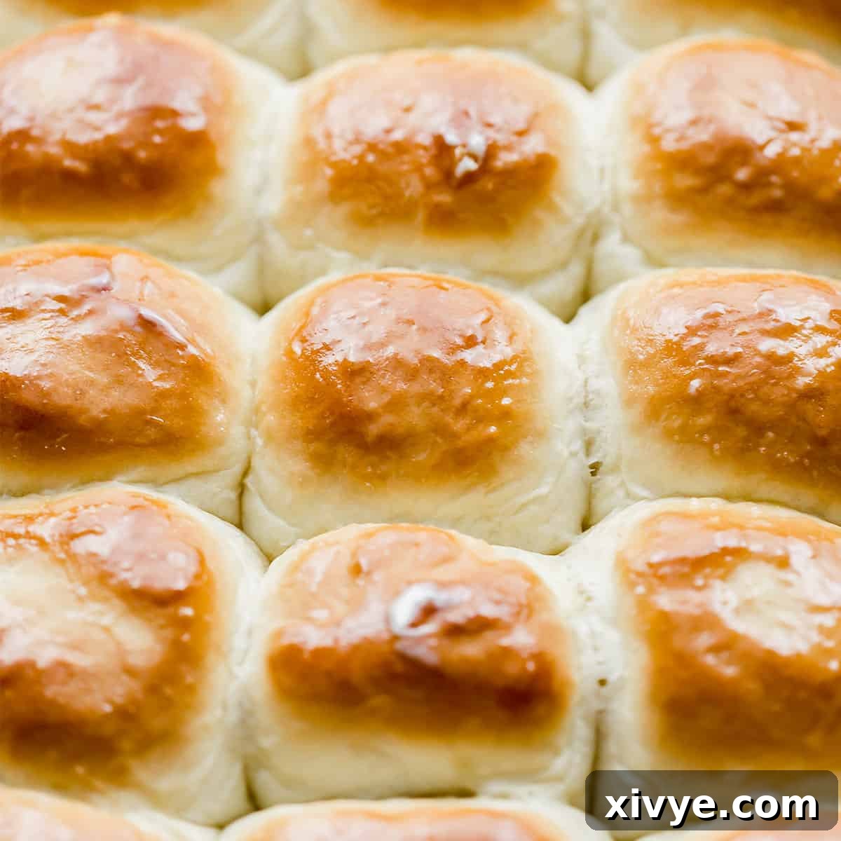 Golden topped homemade rolls topped with melted butter.