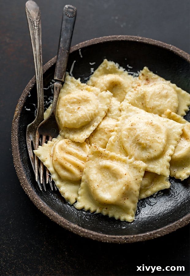 A rustic bowl filled with beautifully crafted butternut squash ravioli, each parcel glistening and promising a delightful, comforting meal.
