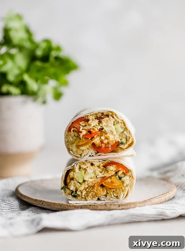 Freshly prepared Avocado Chicken Wraps, neatly arranged on a pristine white plate, showcasing their vibrant ingredients and inviting appeal.