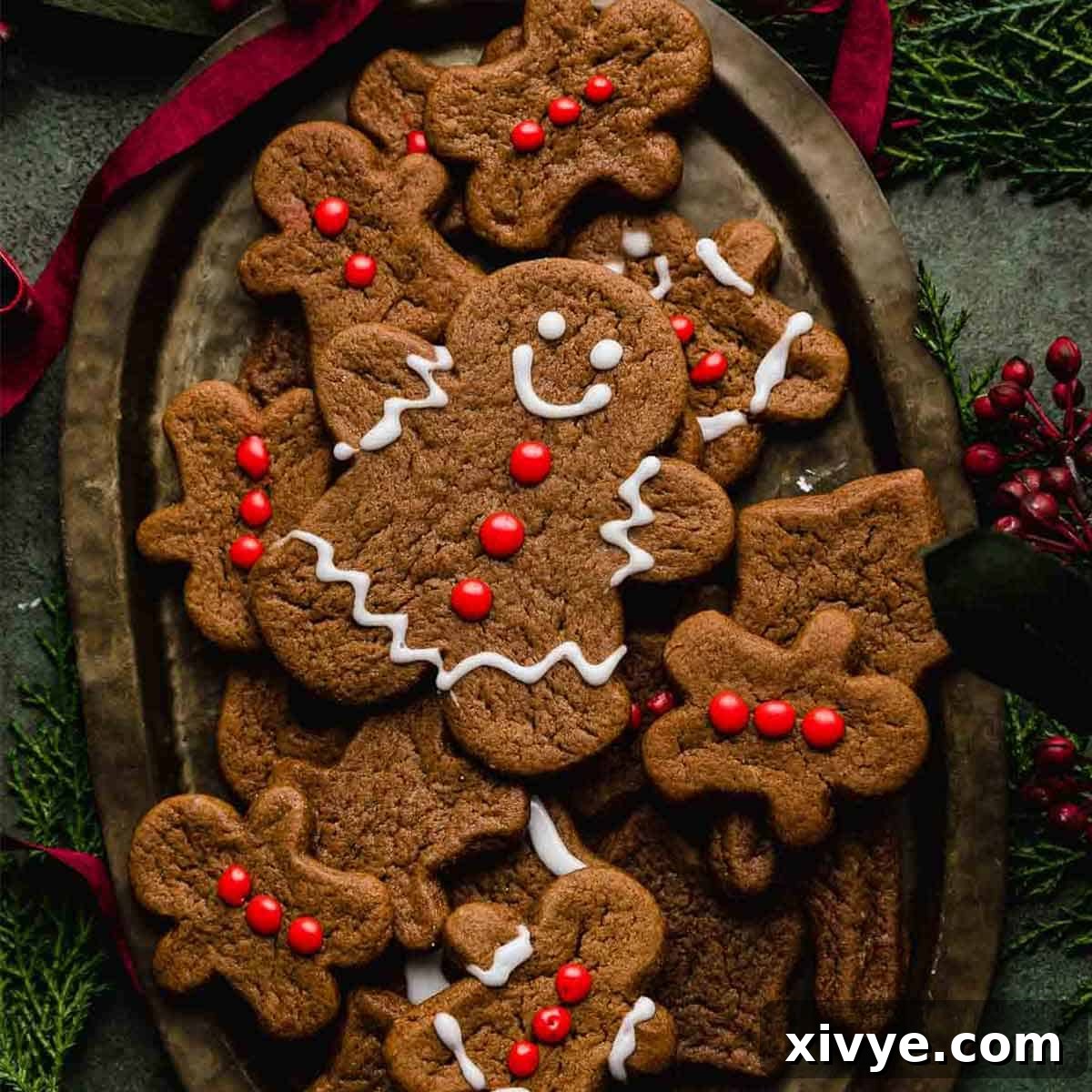 Festive Cookie Favorites Collection 12 A cute gingerbread man cookie decorated with red frosting buttons and white eyes and smile.