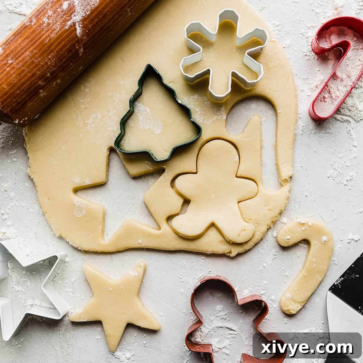 Festive Cookie Favorites Collection 14 Rolled out sugar cookie dough on a white background.