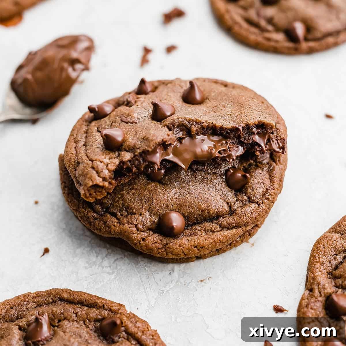 Festive Cookie Favorites Collection 15 A Nutella Stuffed Nutella Cookie cut in half showing Nutella coming from the center.
