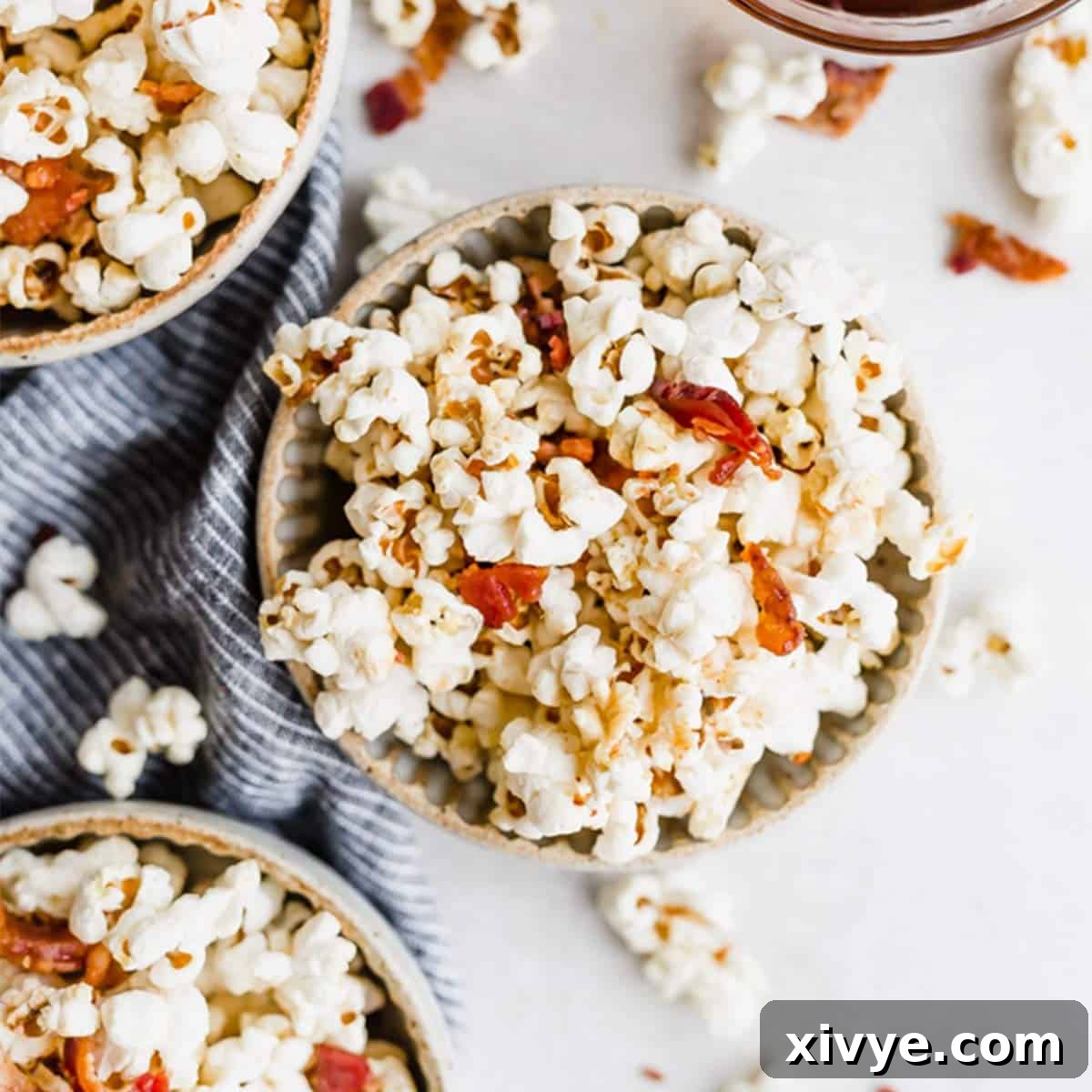 Maple Bacon Popcorn in a bowl on a white background.