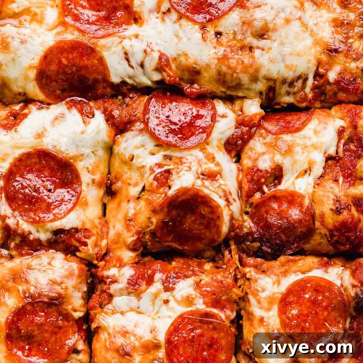 Overhead photo of pepperoni Focaccia Pizza cut into squares.