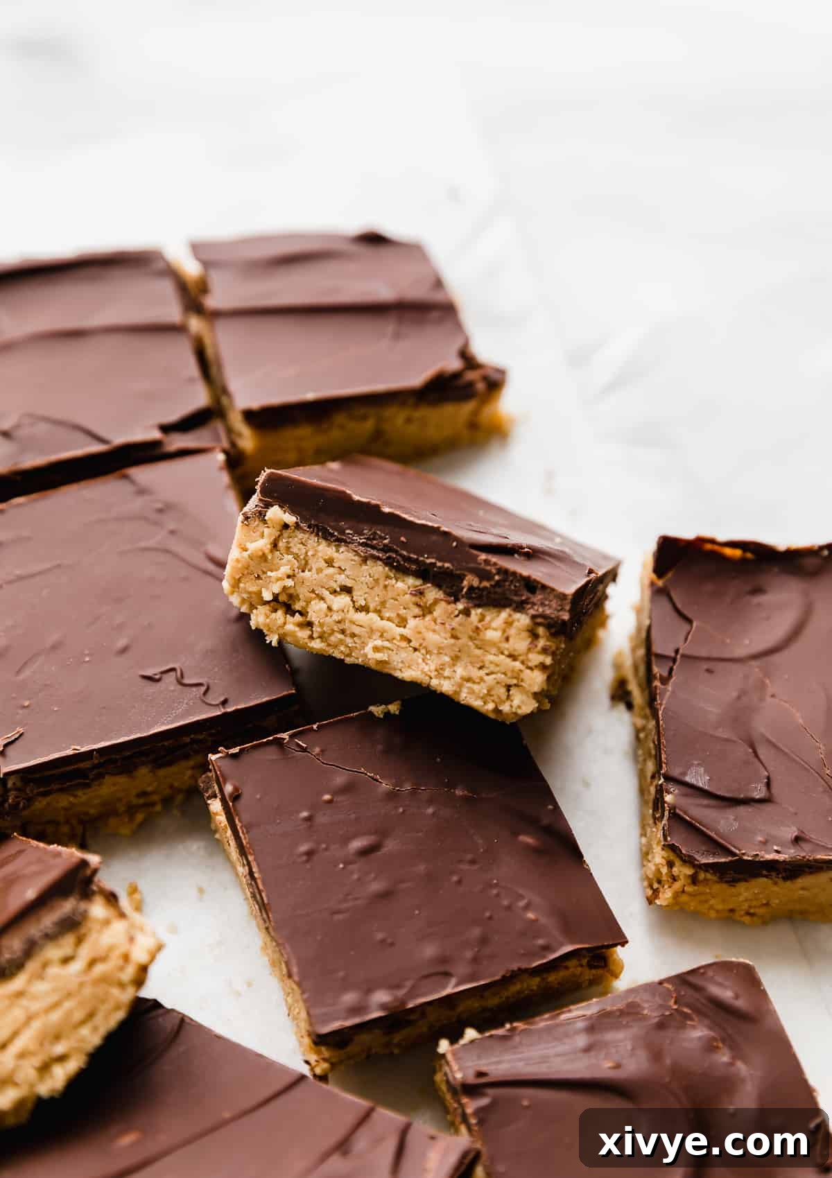 No Bake Chocolate Peanut Butter Bars cut into squares on a white background.