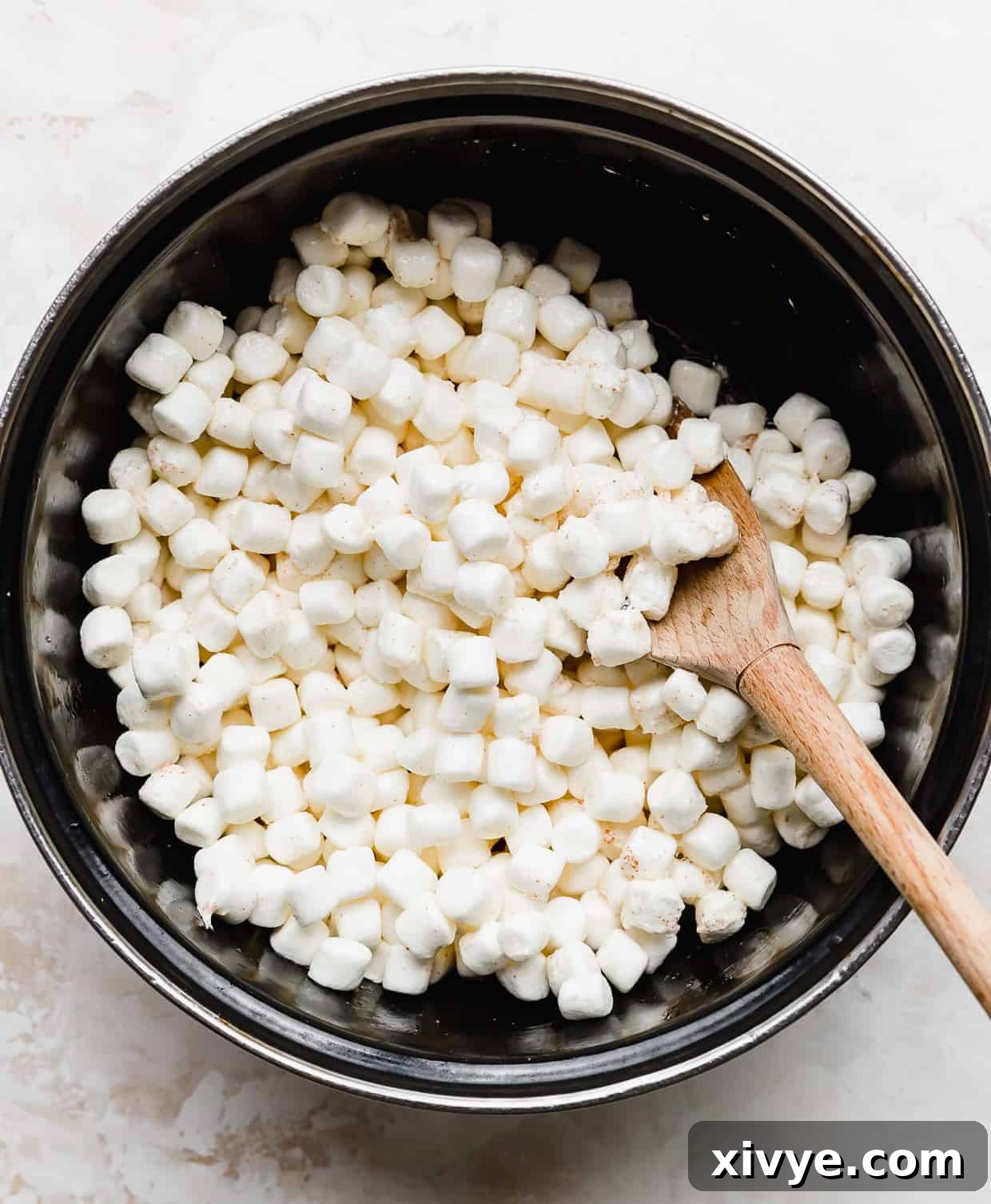 A black pot full of mini marshmallows.